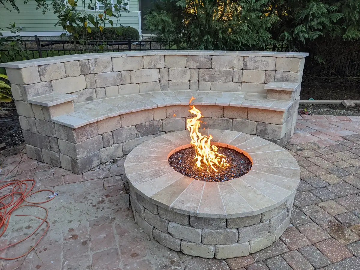 Custom stone fire pit surrounded by natural landscaping in Amelia Island
