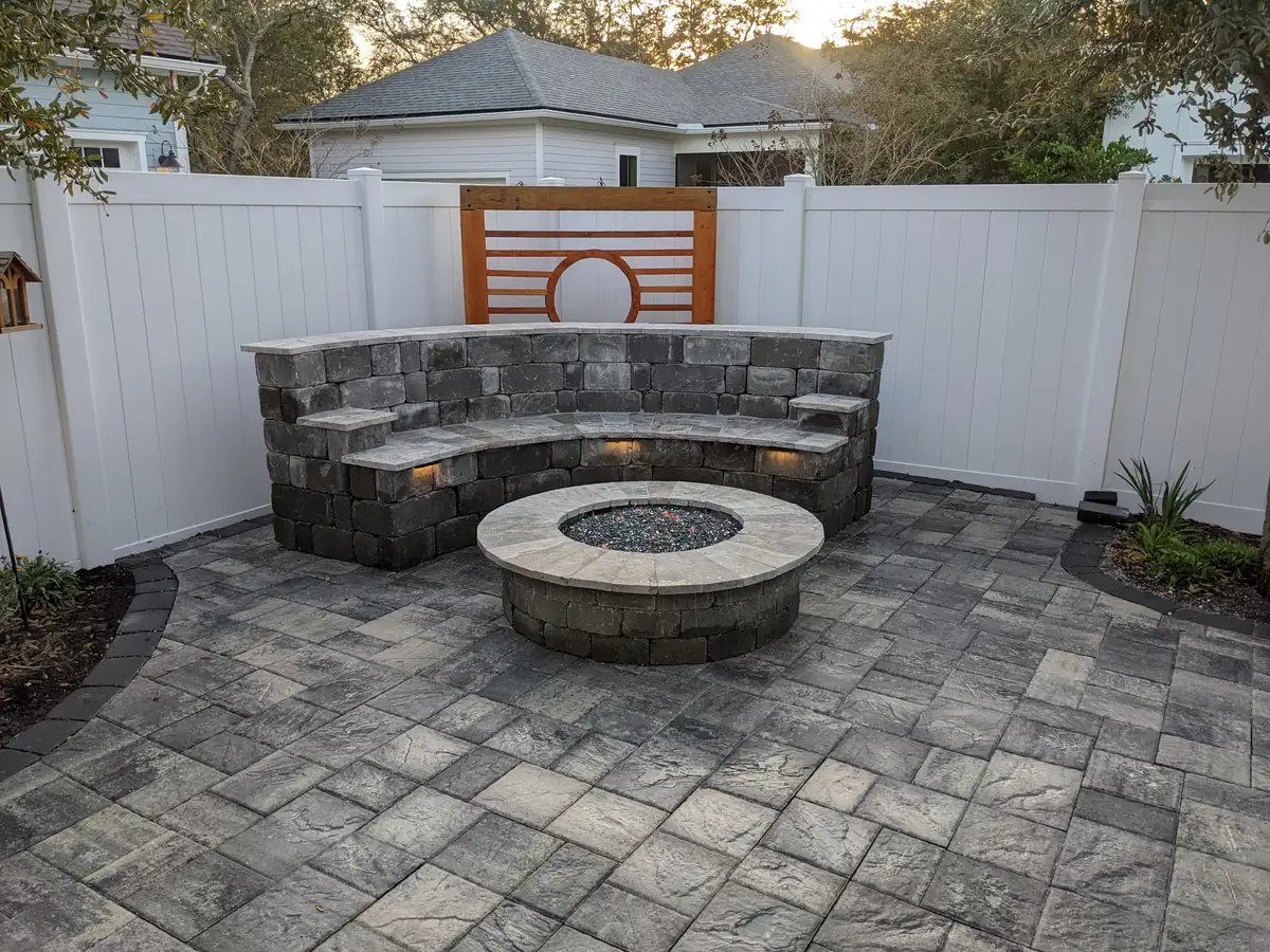 Stone fire pit with surrounding seat wall