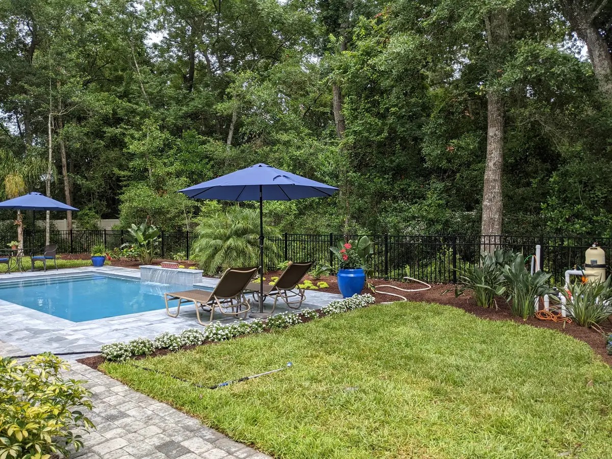 Professional landscape lighting illuminating stone pathway and garden beds