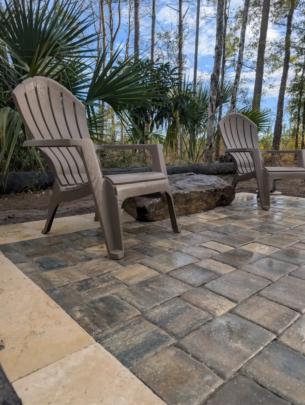 Landscape lighting highlighting a patio and fire pit area